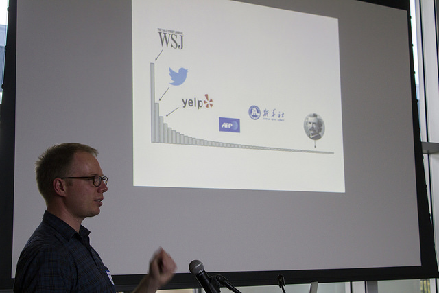 David Bamman presenting graph showing newswire, twitter, and commercial text dominates NLP research